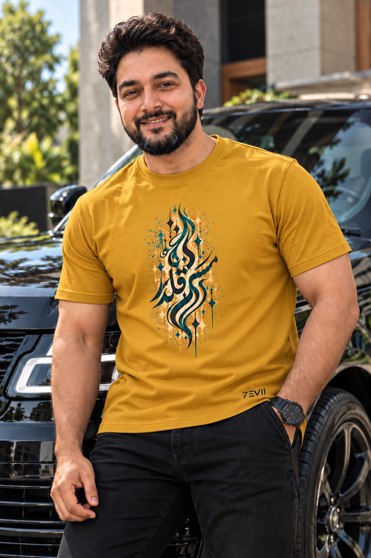 Irf wearing the 7EVII Urdu calligraphy T-shirt in Mustard Yellow, front view