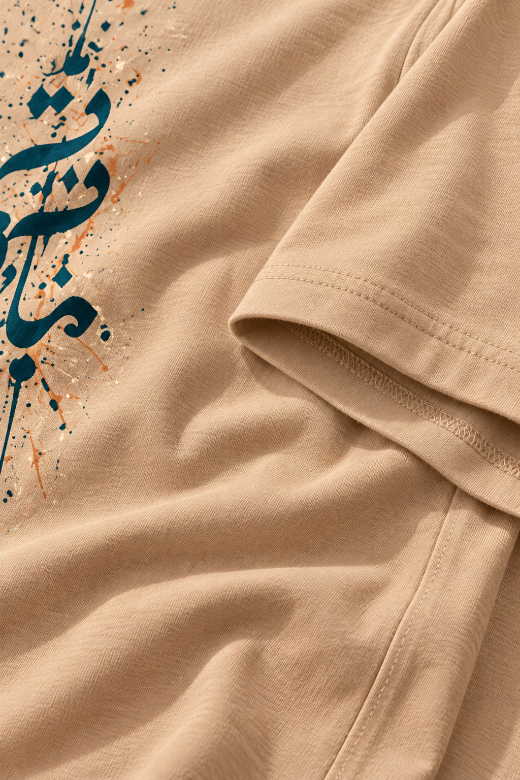 Cotton fabric detail of the 7EVII Urdu calligraphy T-shirt in Sand